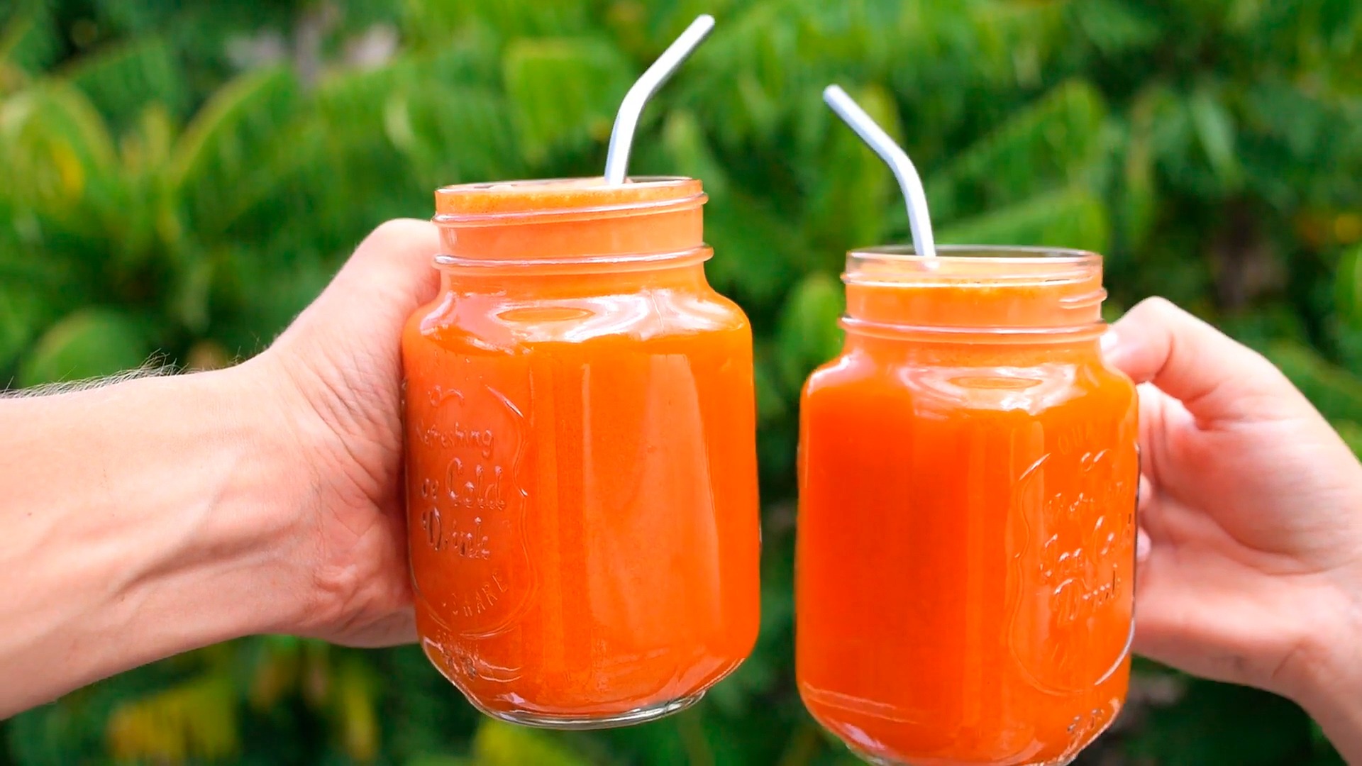 Vibrant sweet potato juice in glass mason jars, the rich orange colour catching the light.